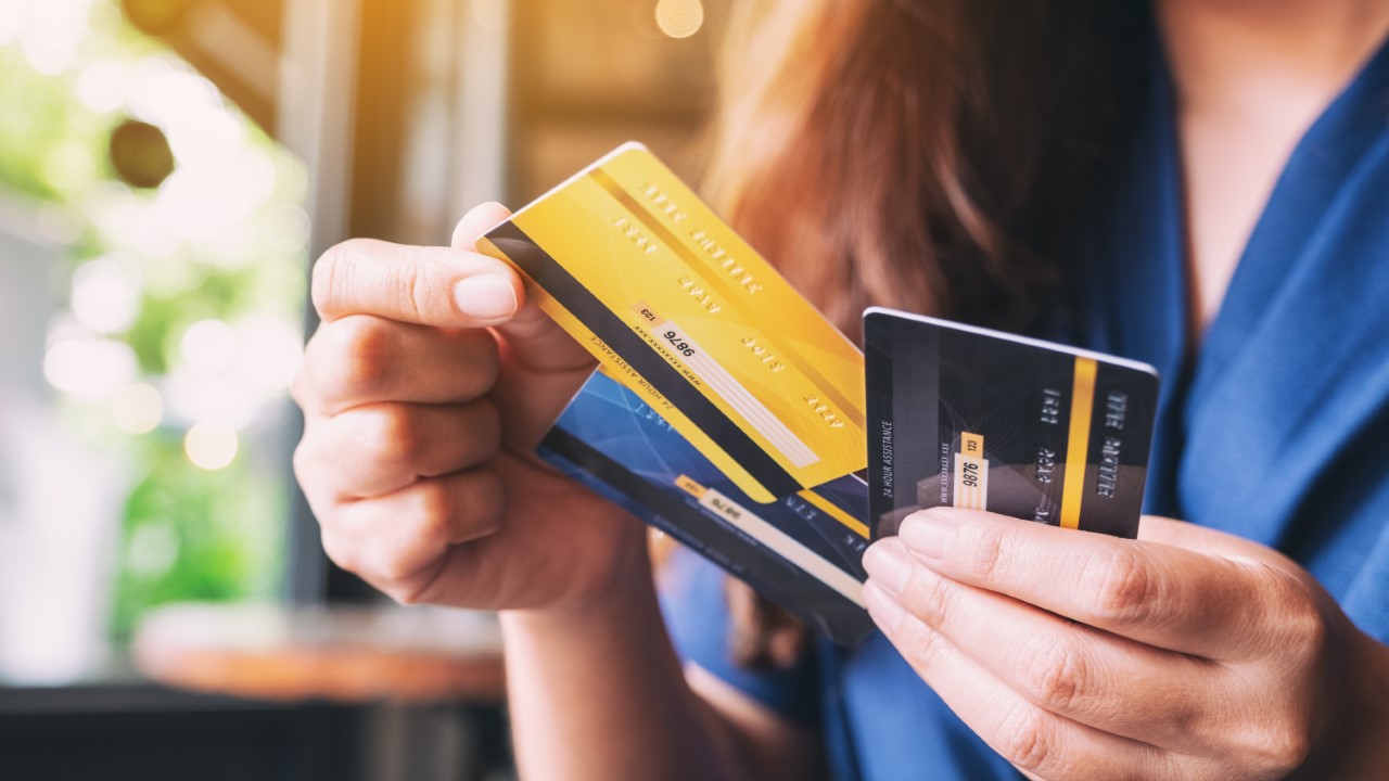 Woman holding credit cards.