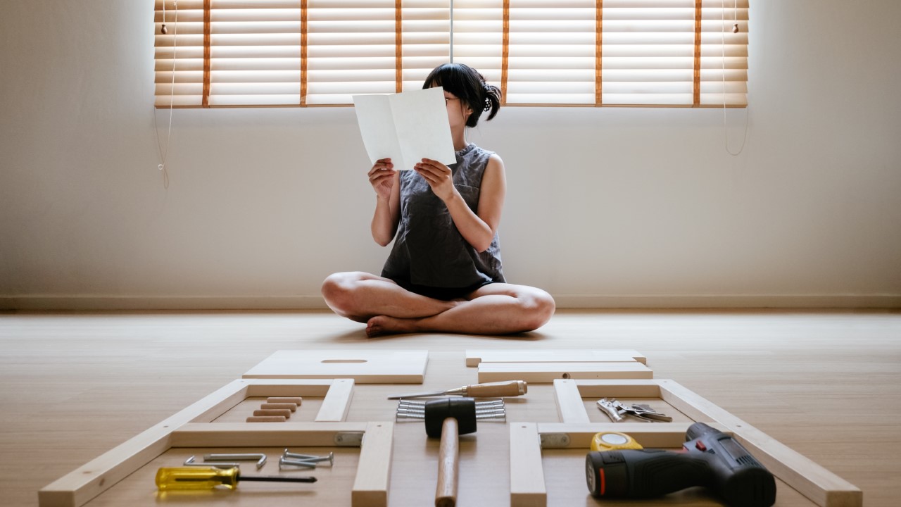 Woman putting together furniture.