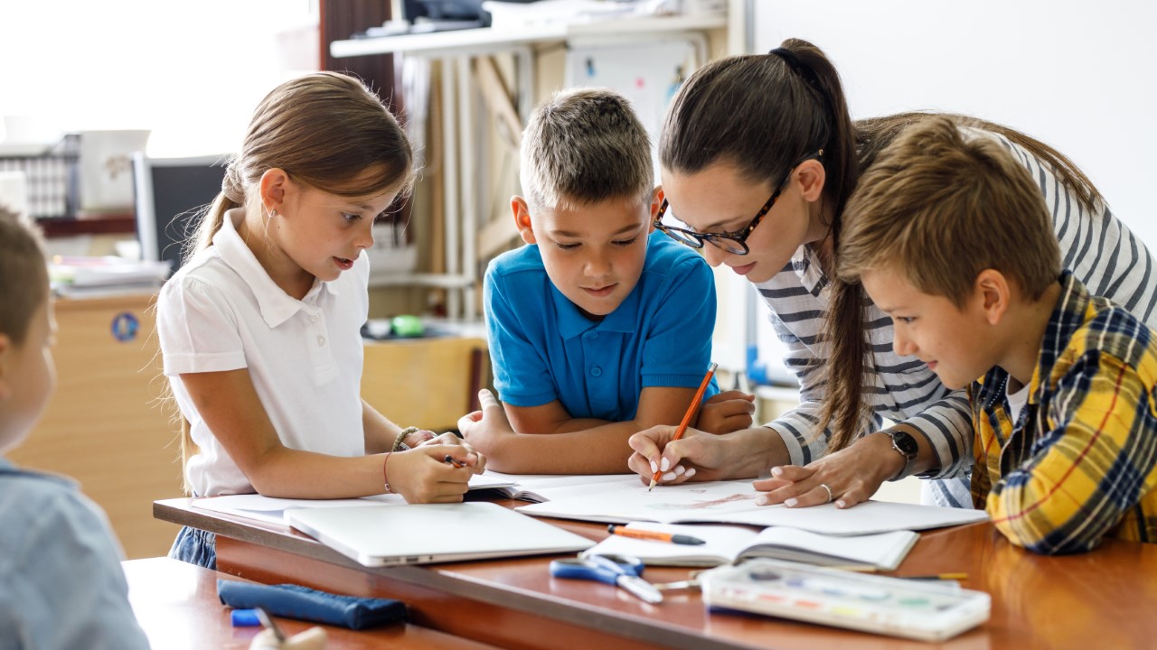 Mom helping kids with school work.