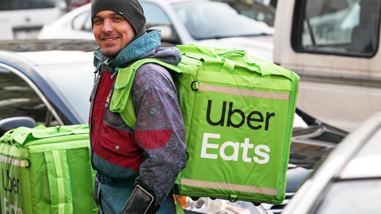 Man with an Uber Eats backpack on.