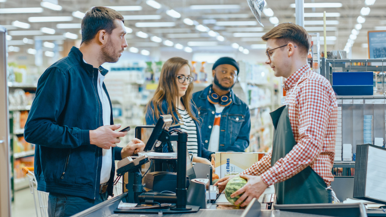 Man questioning cashier about the price of grocery item