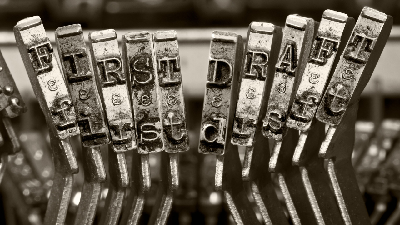 "First draft" keys on a typewriter.