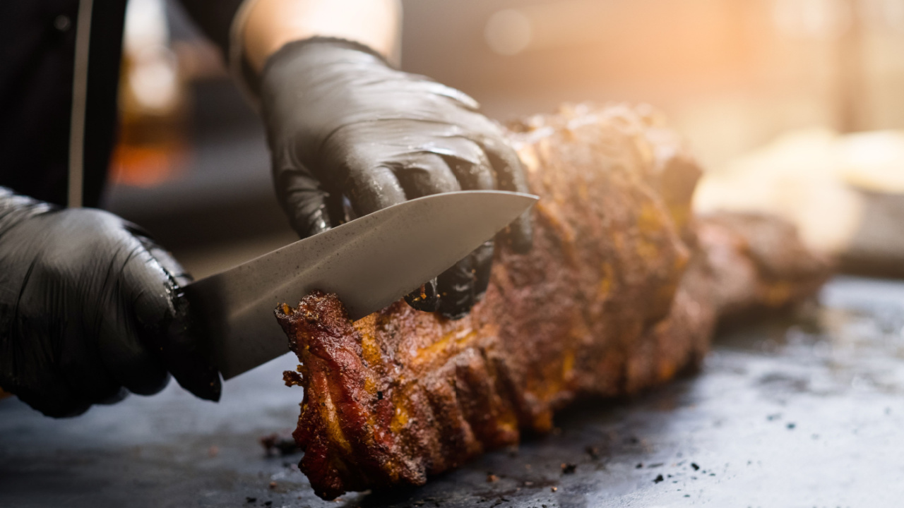 Person cutting meat.