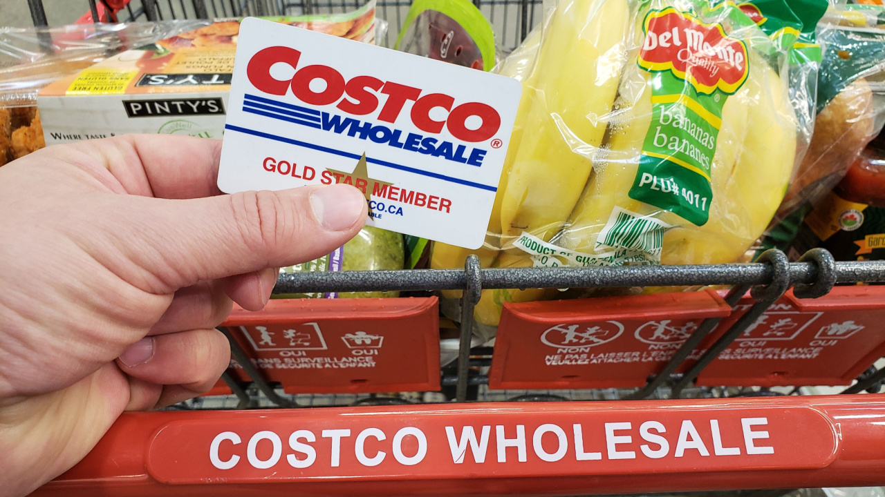 Man holding Costco card while buying in bulk at the supermarket