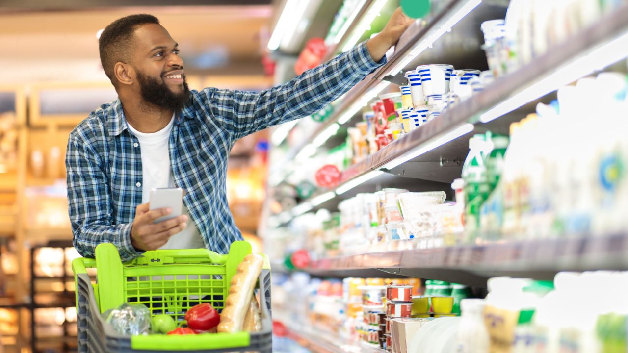 Guy Buys Grocery Choosing Food In Super Market. Empty aisle