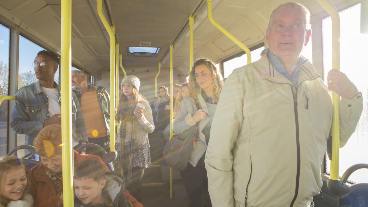 people sitting and standing on a bus