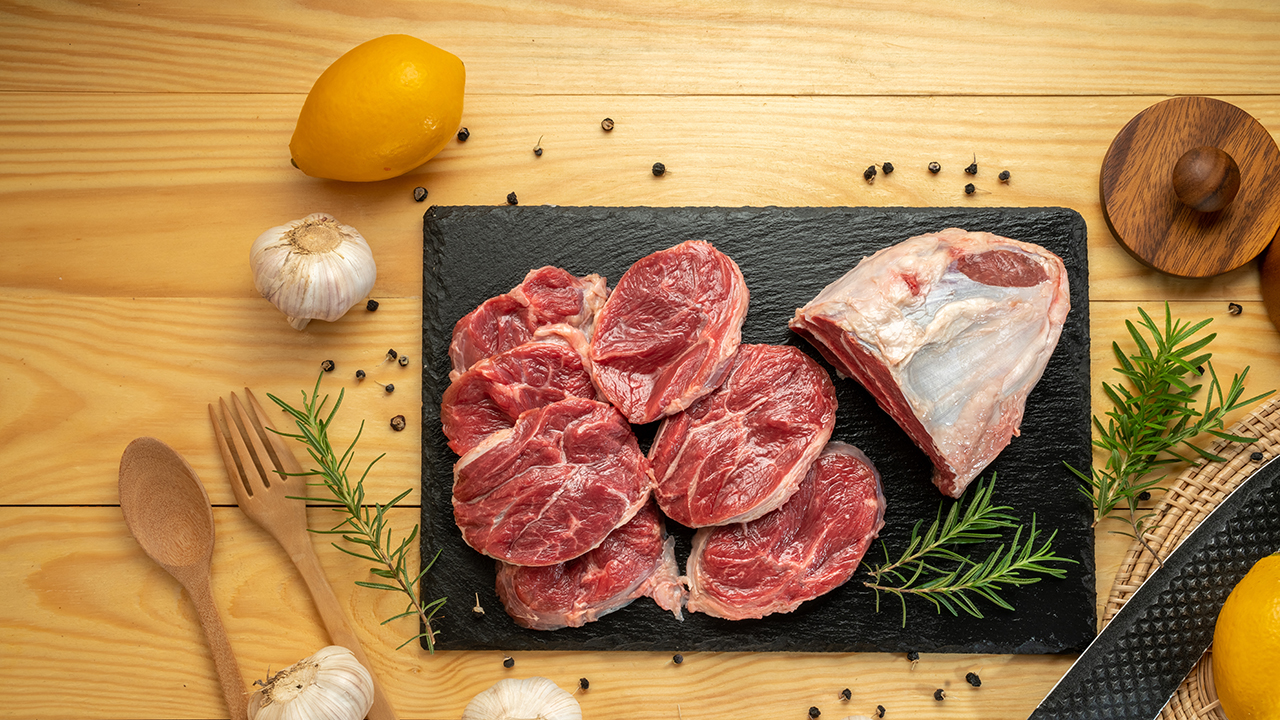 Premium Shank beef in black stone plate on wooden background.Fresh Silver shank meat in black plate on wooden background.