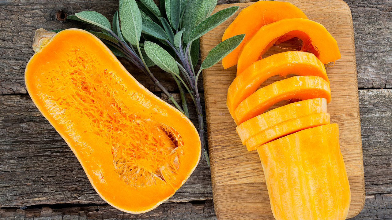 butternut squash over old wood background